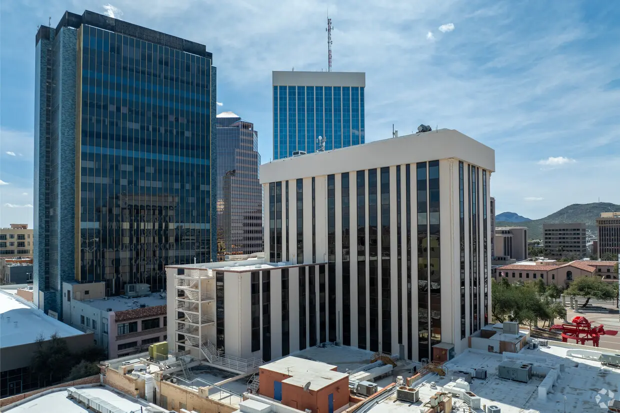 A large building with many windows in the background.